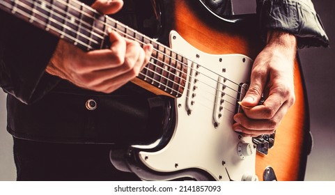 Electric guitar. Repetition of rock music band. Music festival. Man playing guitar. Close up hand playing guitar. Musician playing guitar, live music.