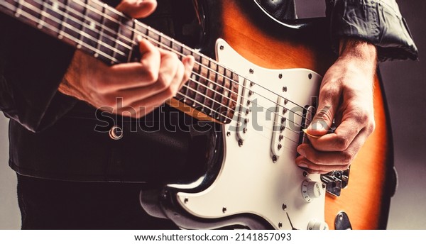 Electric guitar. Repetition of rock music band.\
Music festival. Man playing guitar. Close up hand playing guitar.\
Musician playing guitar, live\
music.