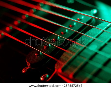 Electric guitar strings close up. Musical instrument details. Concert color contrast lighting. Six-string guitar during performance. Bright colors on dark background. Cinematic light. Copy space