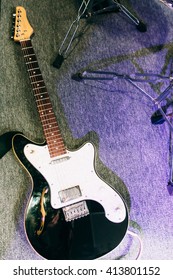 Electric Guitar Top View In Sound Recording Studio. Electric Guitar Flat Lay On Sound Recording Studio Floor. Musical Instrument  Closeup With Free Space.