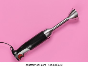 Electric Hand Mixer On Pink Background. Top View