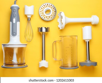 Electric Hand Mixer. Set Of Nozzles And  Containers For Blender On Yellow Background. Top View, Flat Lay
