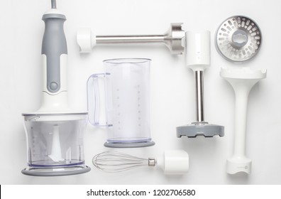 Electric Hand Mixer. Set Of Nozzles And  Containers For Blender On White Background. Top View, Flat Lay
