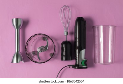 Electric Hand Mixer. Set Of Nozzles And Containers For Blender On Pink Pastel Background. Top View, Flat Lay