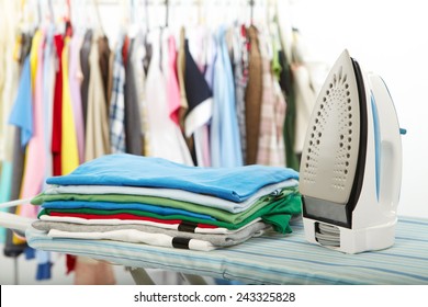 Electric iron and shirt, on cloth background 
