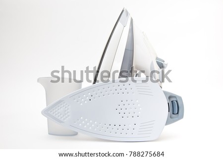 Electric iron with water tank and protector plate for delicate fabrics isolated on white background 