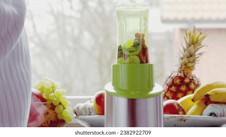 Electric juicer and various fruits on the kitchen counter Healthy living concepts. New Year's resolutions. New start. Weight loss concepts. - Powered by Shutterstock