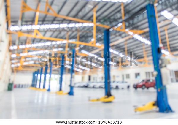 The electric lift for cars in the service put\
on the epoxy floor in new car factory service , Car repair service\
center  background for industry\
