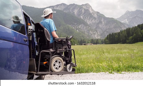 electric lift specialized vehicle for people with disabilities. Empty wheelchair on a ramp with nature and mountains in the back