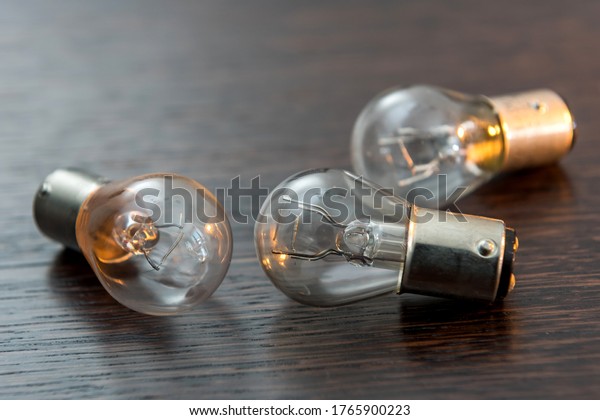 Electric light bulb isolated on\
color background. Eauipment for car headlight,\
technology