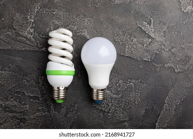 Electric light bulbs. the concept of energy efficiency. LED lamp vs incandescent lamp. Composition on a black marble background. Use an economical and environmentally friendly light bulb concept.
