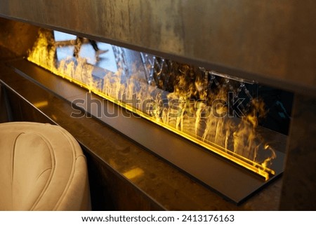 Electric log fireplace. Restaurant showcase decorated with artificial heater. Exterior design.