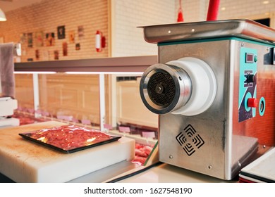 An electric meat grinder in a butcher shop - Powered by Shutterstock