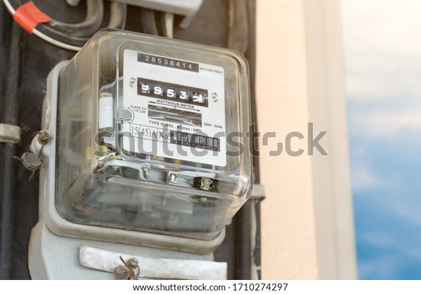 Electric\
meter with blue sky and sun light. Watt hour meter with copy space.\
Electric  equipment for measure power\
usage.