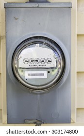 Electric Meter Mounted On The Side Of A House.