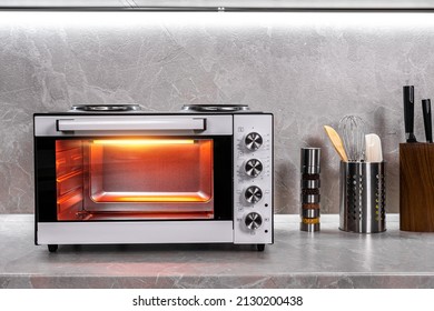 Electric mini oven for homemade cooking - Shutterstock ID 2130200438