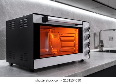 Electric mini oven for homemade cooking - Shutterstock ID 2131154030