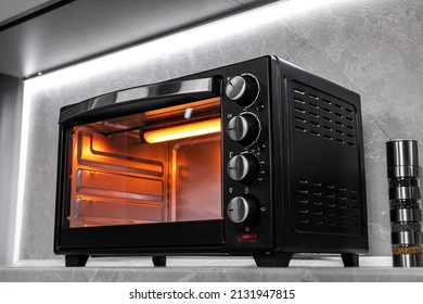 Electric mini oven for homemade cooking - Shutterstock ID 2131947815
