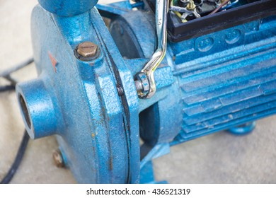 Electric Motor  And Man Working Equipment Repair On Cement Floor Background.Background Motor Or Equipment.Close Up.