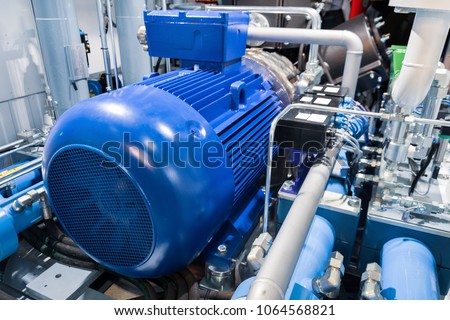 Electric motor of a powerful industrial gas compressor. Abstract industrial background.
