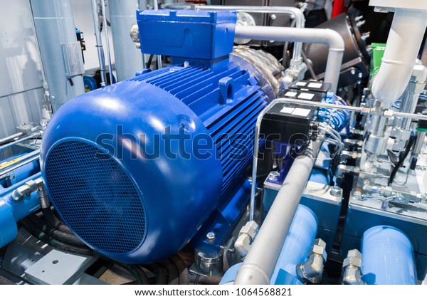 Electric motor of a powerful industrial gas\
compressor. Abstract industrial\
background.