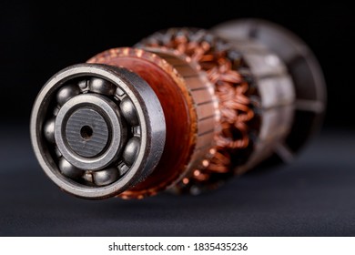 Electric Motor Rotor On A Dark Table. Accessories For Overhaul And Repair Of Engines. Black Background.