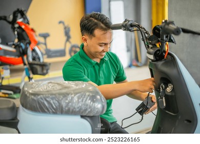 electric motorcycle charged at charging station by male asian - Powered by Shutterstock