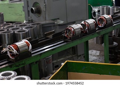 Electric Motors Manufacture In Industrial Company - Stators On Assembly Line Of Semi-automated Manual Production. 20th Century Technology, Obsolete Factory Processes Concept.