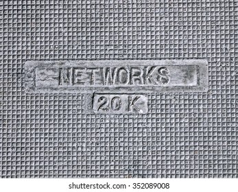 electric networks, twenty kilo-volts as text on vintage metal manhole, modern telecommunication details - Powered by Shutterstock