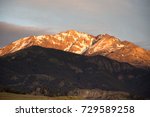 Electric Peak at Sunset with the foothills, valley and Roosevelt Arch in the foreground. Photographed in Yellowstone National Park in natural light.