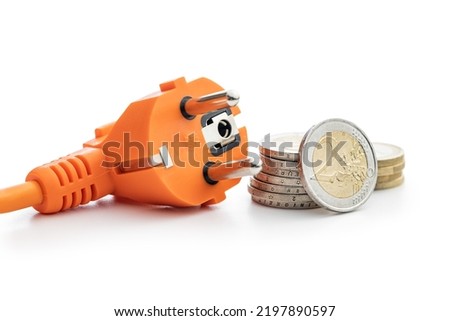 Electric plug and euro coins isolated on the white background. Concept of increasing electricity prices.