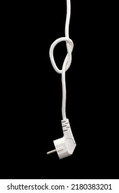 Electric Plug For A Socket With A Knot On A Cable On A Black Background. The Concept Of The Inability To Get Energy Or Electricity. No Access To Electricity Or Power Outages