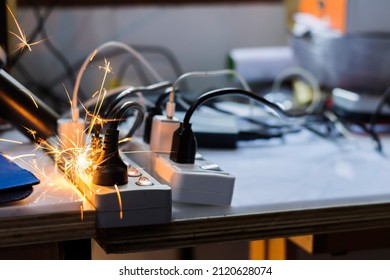 electric plug sparks Caused by short circuit The concept of danger, the use of non-standard equipment worn-out equipment - Shutterstock ID 2120628074