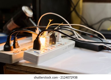 electric plug sparks Caused by short circuit The concept of danger, the use of non-standard equipment worn-out equipment - Shutterstock ID 2124072938