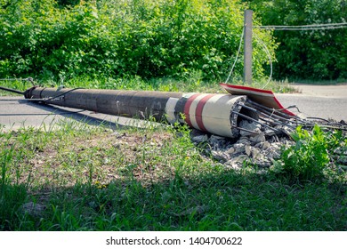 Electric Pole. Broken Broken Wood Power Line Post With Electrical Components On The Ground After Accident.