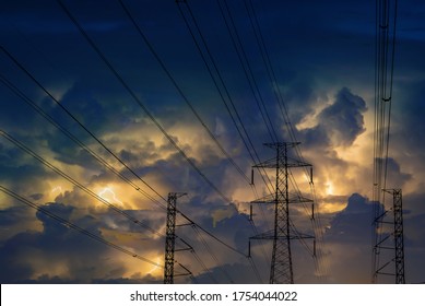 Electric Pole And Line On Dangerous Scary Horror Yellow Lightning Blue Sky At Night. Electric Post Transfer Electric Power On Fear Storm Cloudy Sky Background