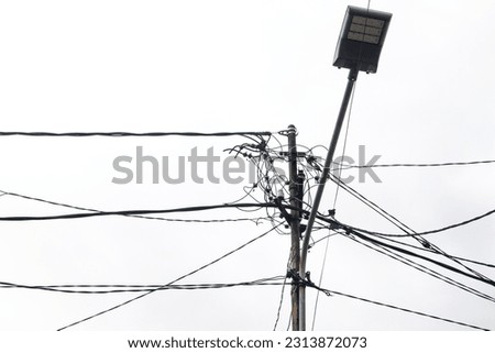 electric pole with messy wires isolated on white background