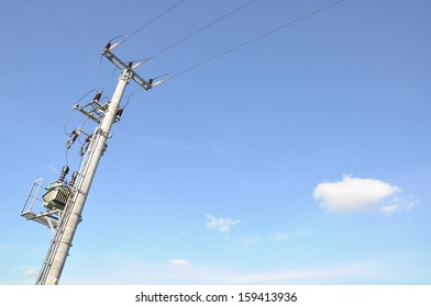 Electric Pole With A Transformer On A Background Of Blue Sky