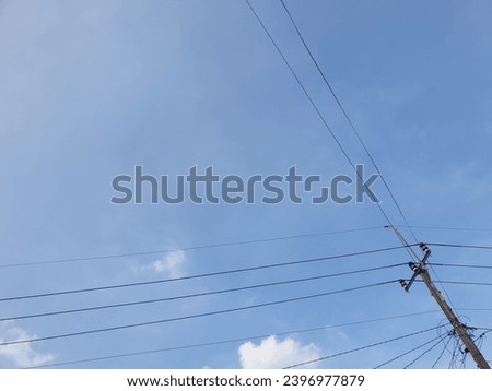 Electric poles against a bright blue sky background