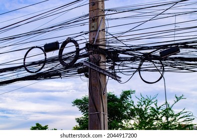 Electric Poles With Tangled Electrical Wires Nestled On Foot.