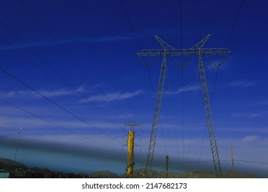 electric pople low angle view concept powerful machine light pole connecting no people infrastructure silhouette cloud metallic overhead tall generator lines cables low angle building watt
