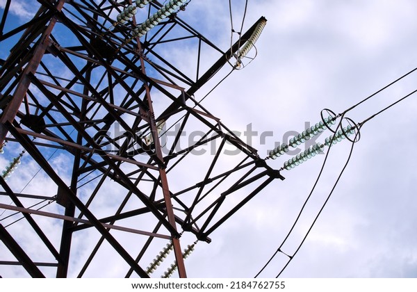 Electric power lines divided by safe guard\
insulating frame transfening safely high voltage electrical energy\
through cable wires. Electricity transmission on long distance\
concept