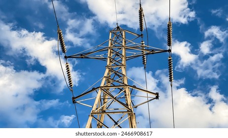 Electric Power Lines and Tower Against Blue Sky and Clouds - Powered by Shutterstock