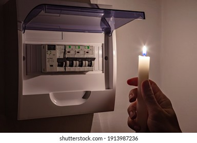 Electric Power Outage At Home Or Blackout, Concept Image. Electrical Fuse Panel In The Darkness At Home