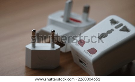 Electric power plug adapter on a table.
