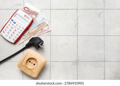 Electric power plug and socket with calculator and euro banknotes on light tile background