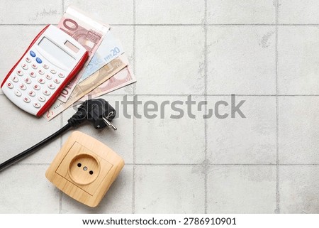 Electric power plug and socket with calculator and euro banknotes on light tile background