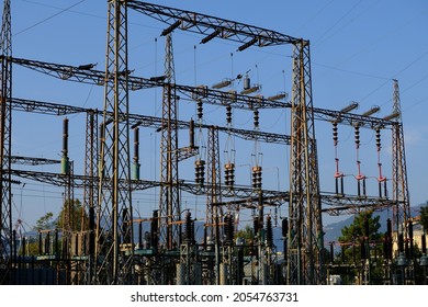 Electric power pylon. High voltage electrical pylons. Electricity transformation and distribution center. Silouette on blue sky.