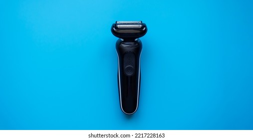 Electric razor on a blue background close-up. Razor. Male set.