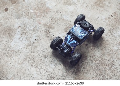 Electric Remote Toy Car Isolated On Rough Floor